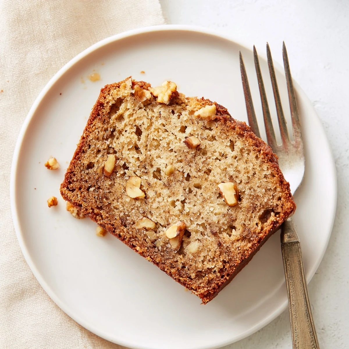 Freshly baked moist banana bread cooling on wire rack with perfectly risen domed top and golden crust