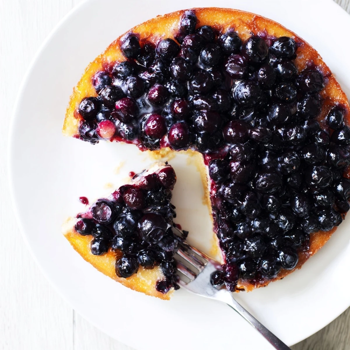 Warm blueberry upside down cake fresh from the oven with bubbling caramelized berry topping