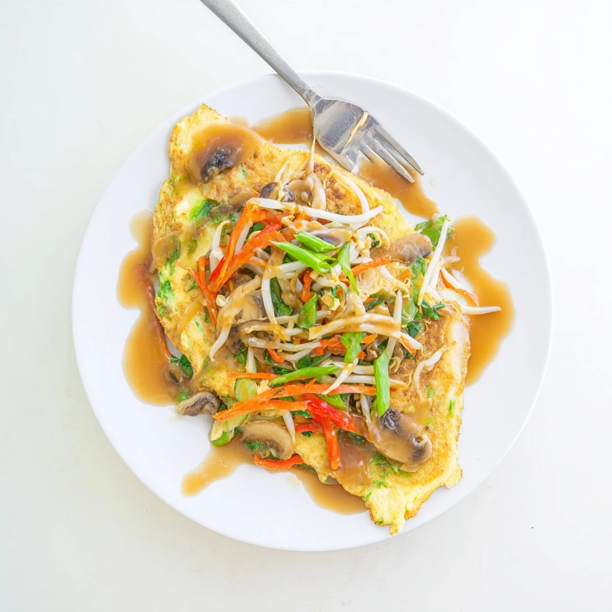Homemade Chinese-American Egg Foo Young with bean sprouts served over steamed white rice