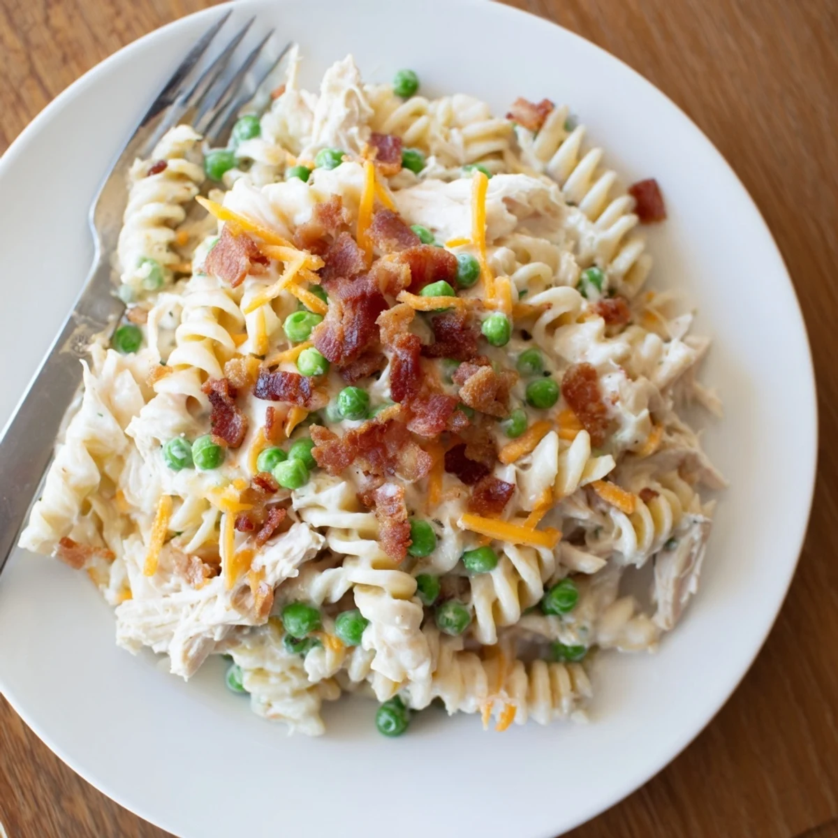 Creamy Crock Pot Crack Chicken Casserole topped with melted cheddar and crispy bacon bits