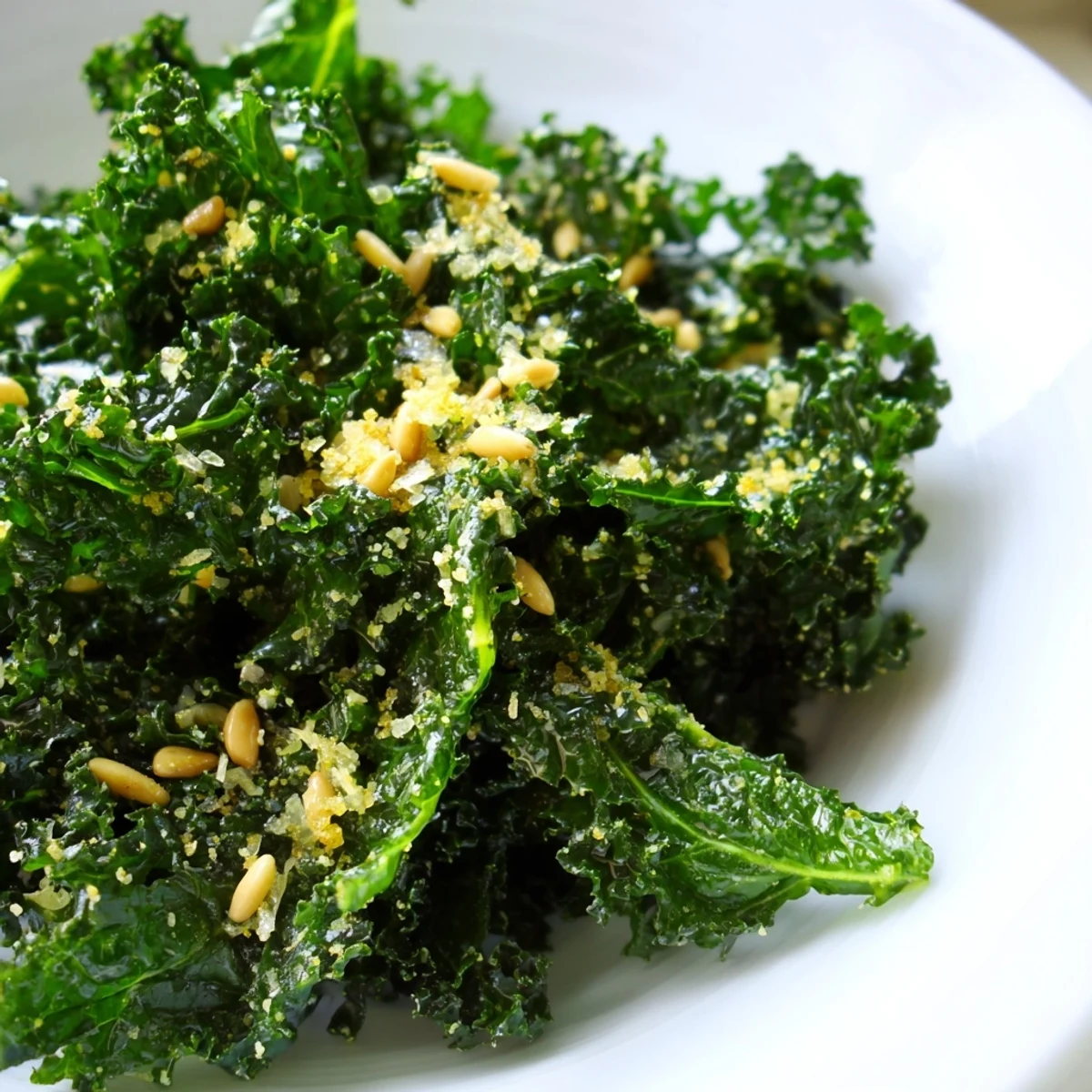 Massaged kale leaves glistening with zesty lemon garlic dressing and shaved Parmesan