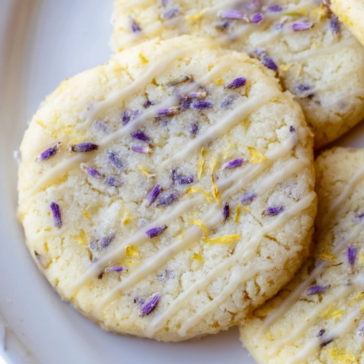 Golden lemon lavender cookies with crisp edges, served on a rustic white plate