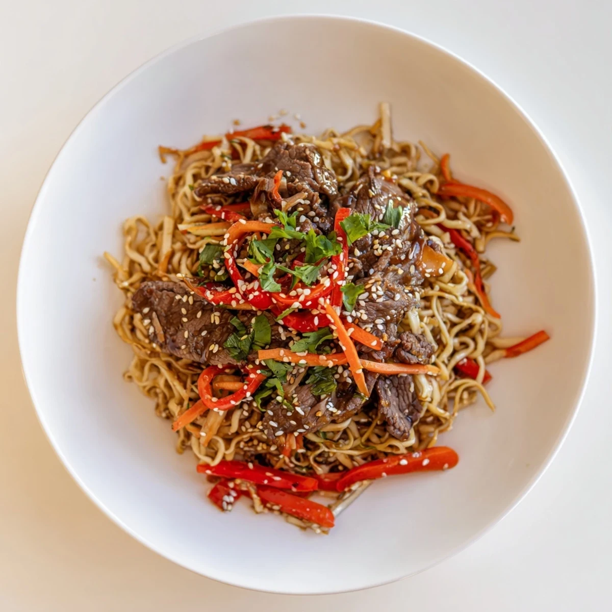 Chunky vegetables and chewy noodles in Sticky Beef Noodles, served hot