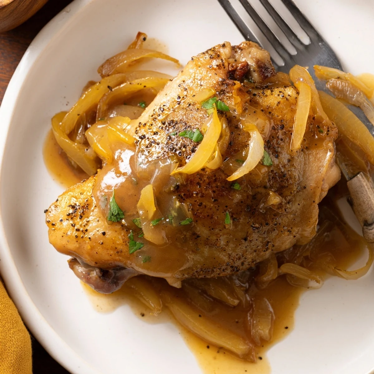 Savory Smothered Chicken Thighs In Rich Gravy Recipe plated over creamy mashed potatoes