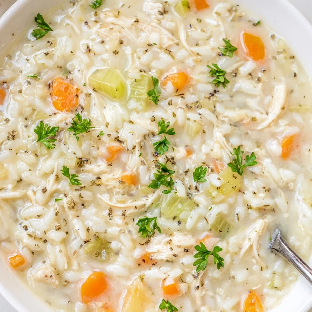 Hearty Creamy Chicken Rice Soup ladled over crusty bread for cozy nights  
