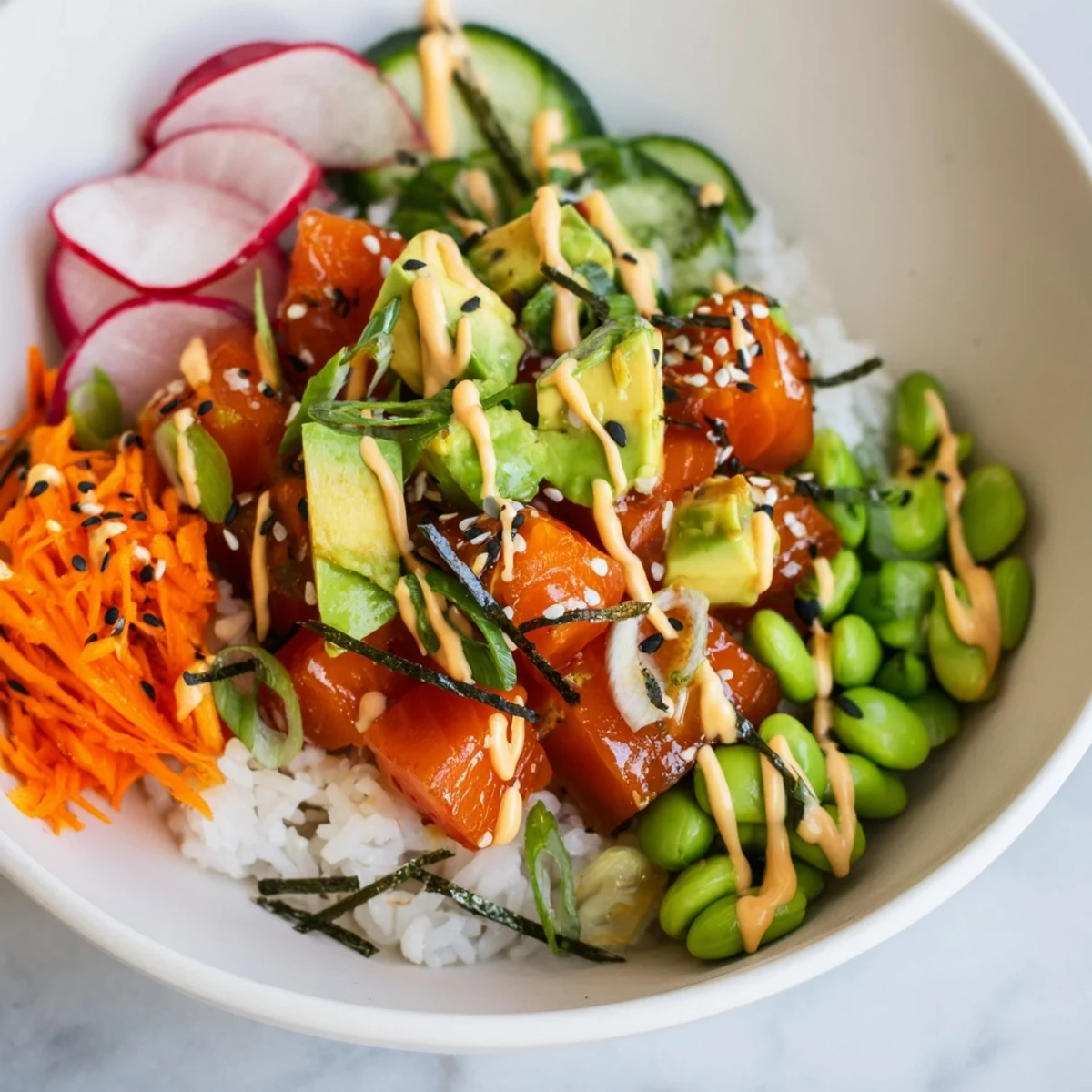 Fresh salmon and avocado poke bowl featuring marinated raw fish, sliced vegetables, and seasoned sushi rice.