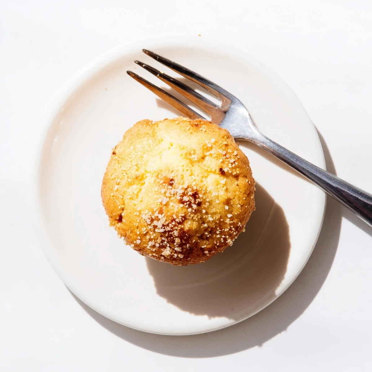 Freshly baked lemon cream cheese muffins split open revealing creamy citrus center filling