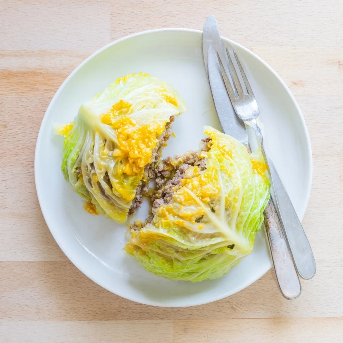 Juicy ground beef oven baked cabbage burger plated with sesame seeds and fresh herbs