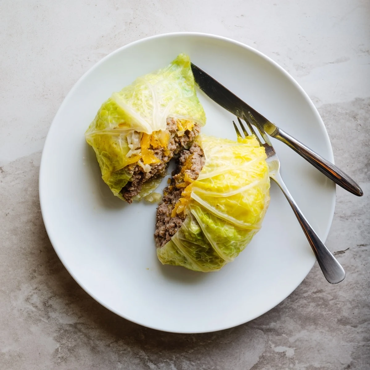 Oven baked cabbage burger wrapped in blanched cabbage leaves drizzled with olive oil