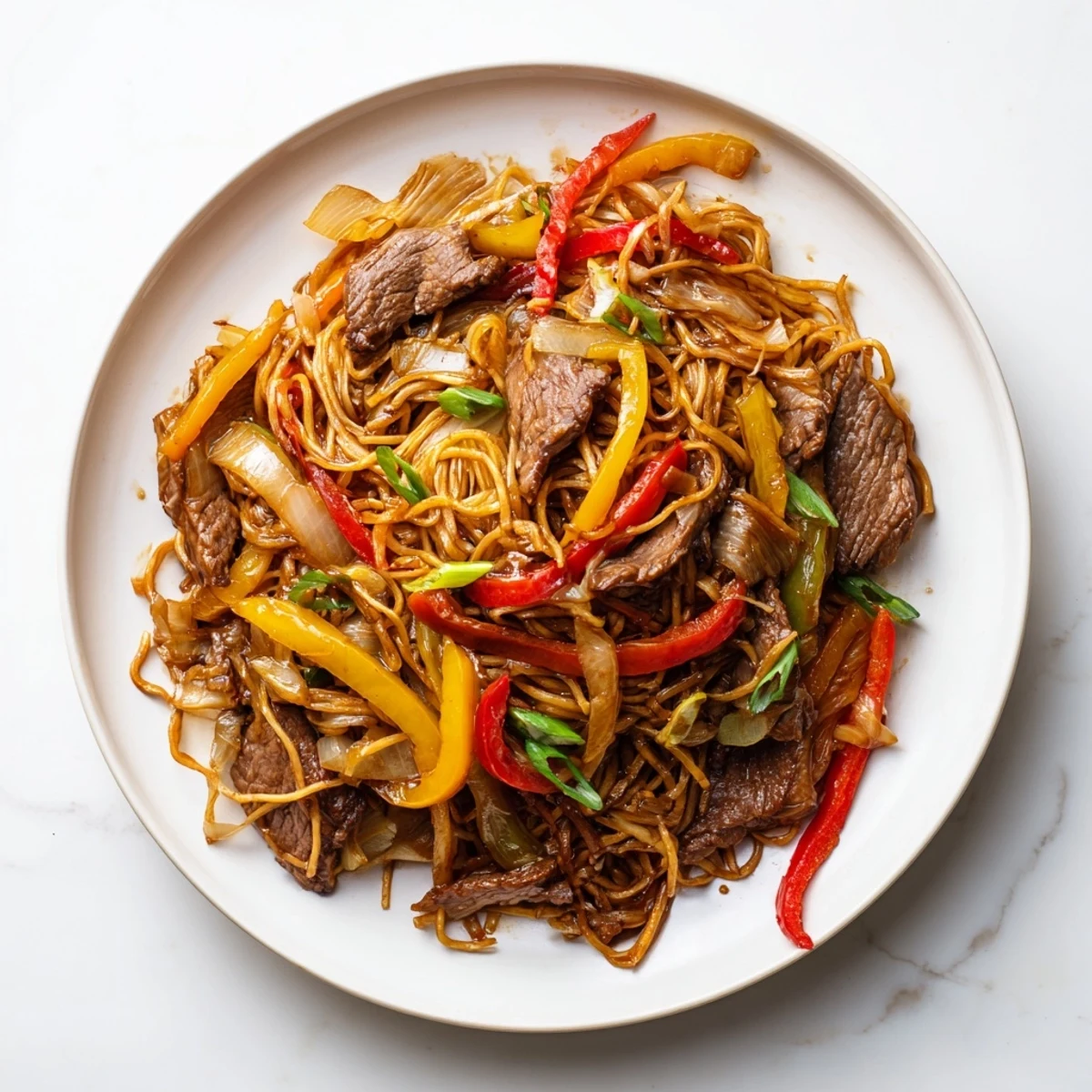 Sizzling beef chow mein noodles tossed with crisp vegetables and rich sauce