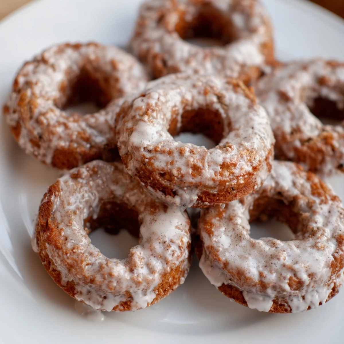 Freshly baked banana bread donuts with moist tender crumb and optional powdered sugar coating