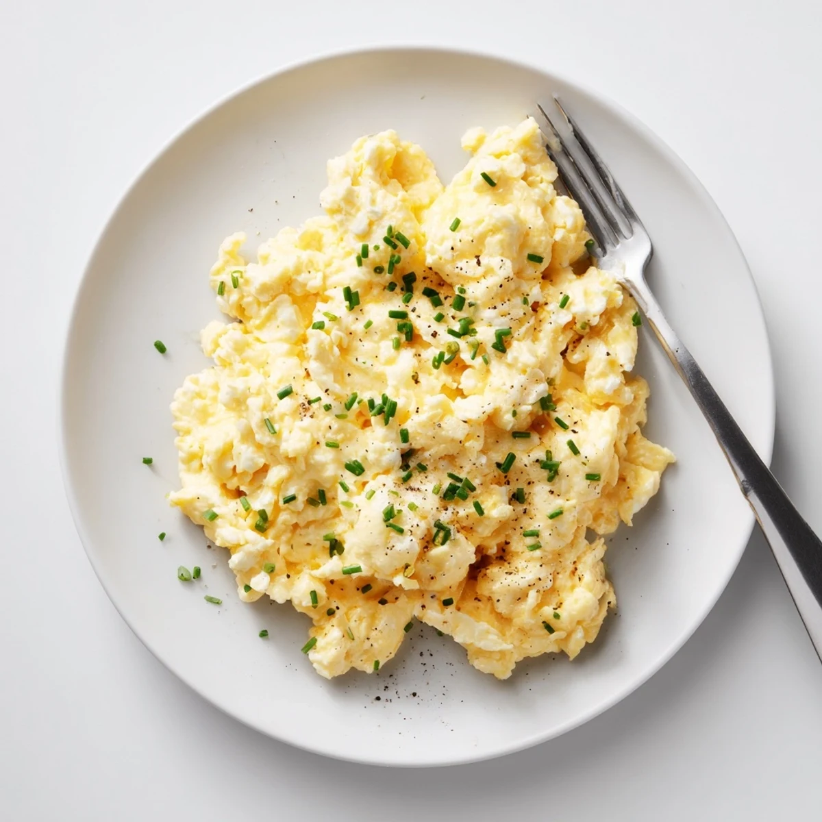 Warm Cottage Cheese Scrambled Eggs With Chives, soft curds folded in buttered skillet