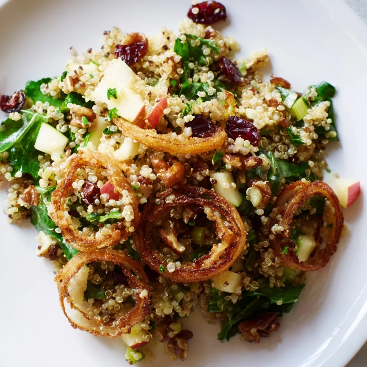 Tangy honey mustard dressing coats fluffy quinoa with bright diced apples and cranberries