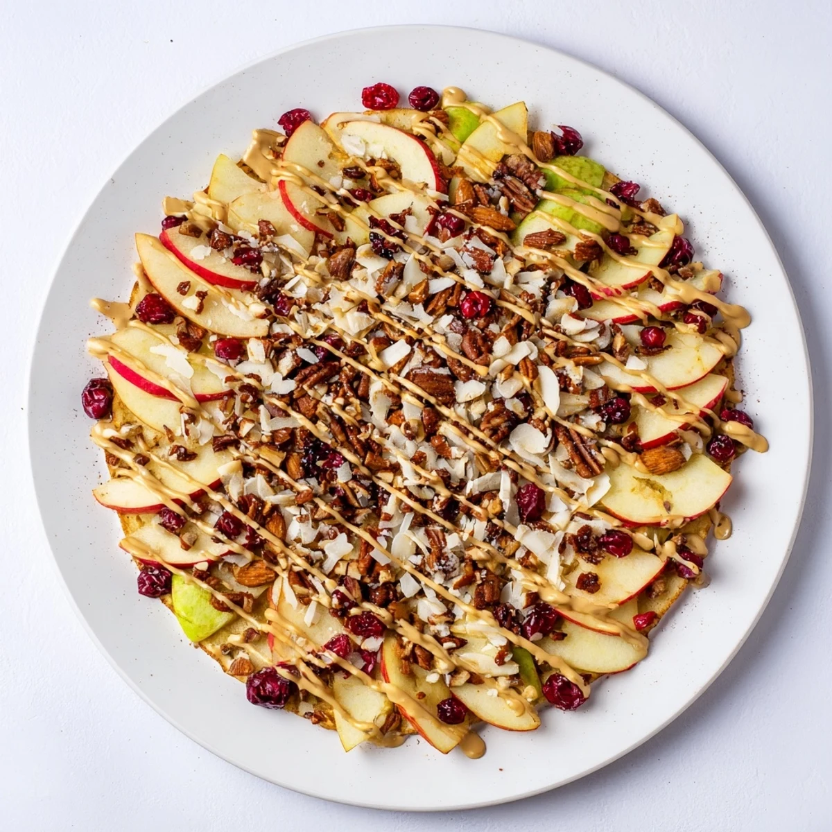Crispy apple nachos drizzled with warm cinnamon tahini and loaded with crunchy toppings