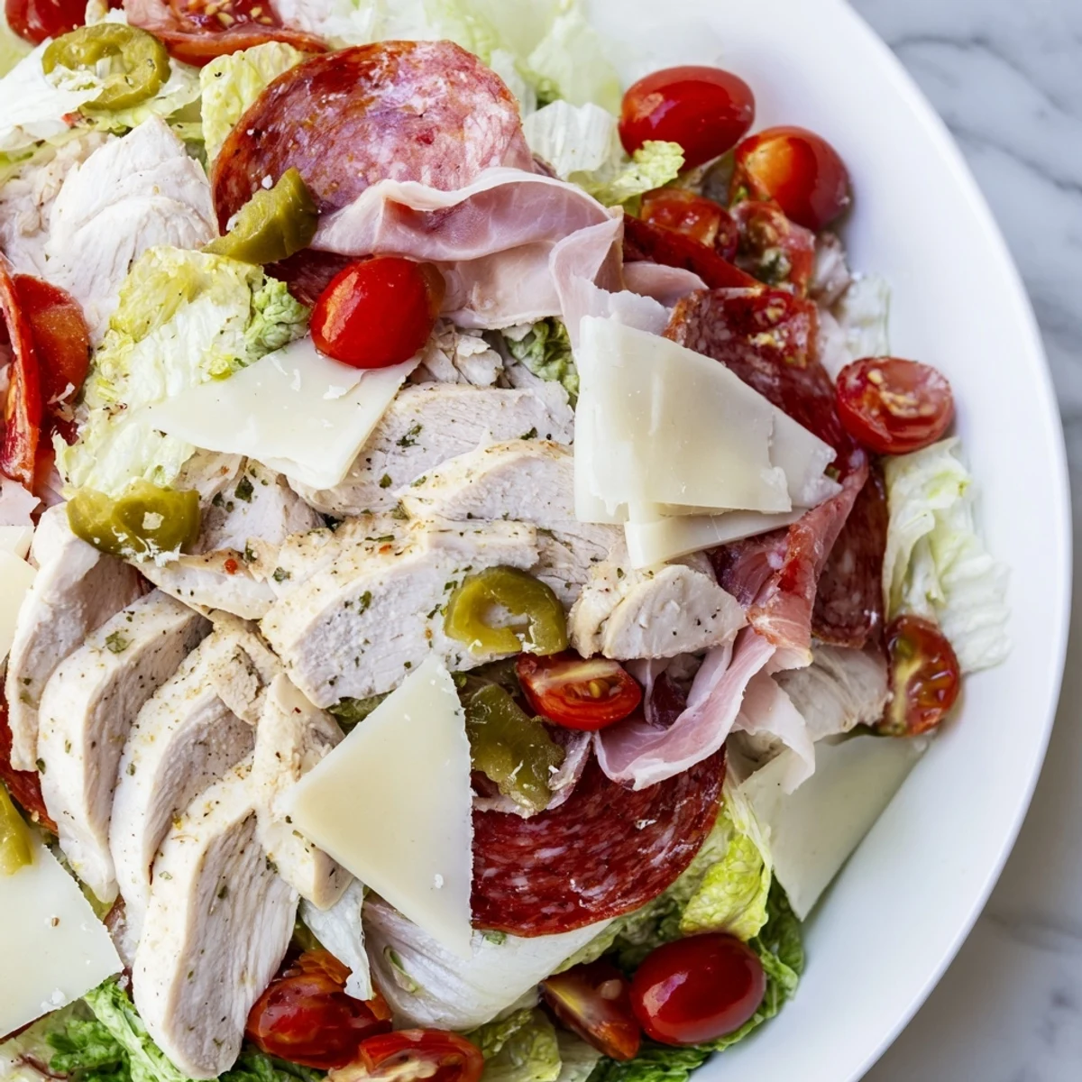 Juicy grilled chicken crowns this Italian grinder chicken salad layered with provolone and fresh vegetables.