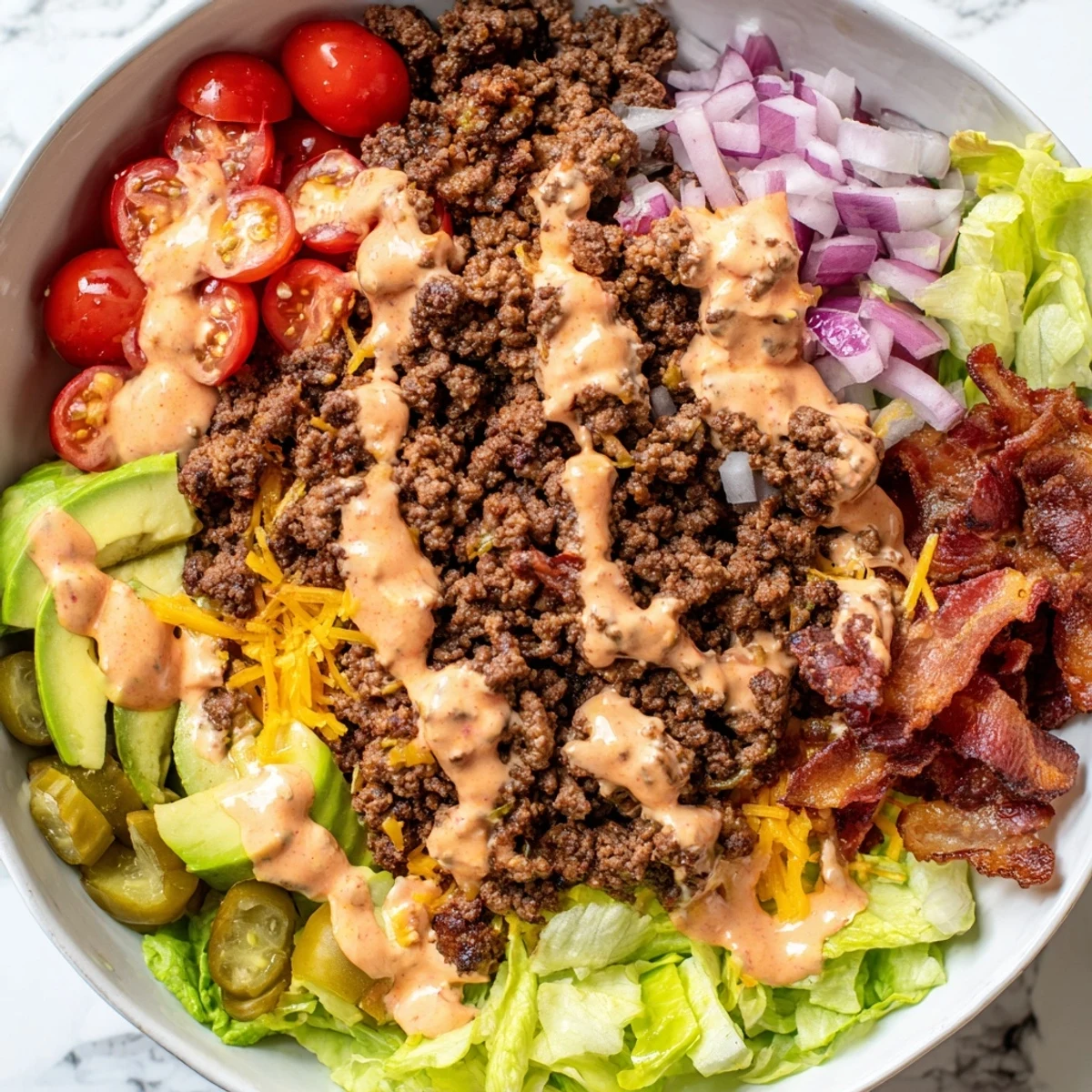 Juicy Burger Bowls with seasoned beef and melted cheddar on crisp romaine lettuce